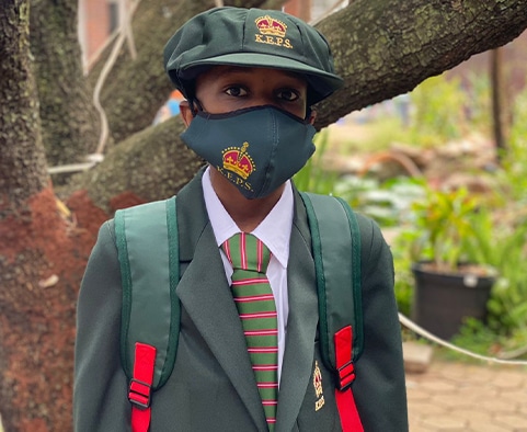 Young Boy Wearing KEPS School Uniform & Branded Surgical Mask
